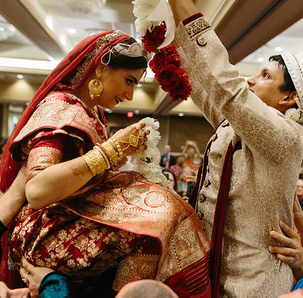 a bride and groom at a traditional Indian wedding in the grand ballroom